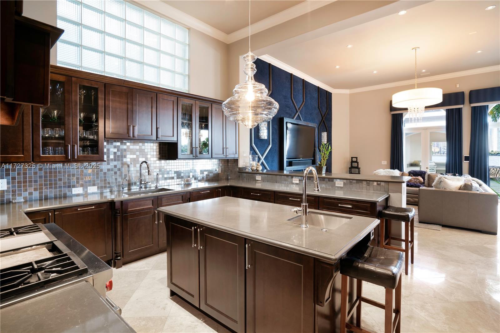 3914 Island Estates Drive Aventura, FL 33160 - Photo 33 of 40 a kitchen with granite countertop a sink stainless steel appliances and cabinets