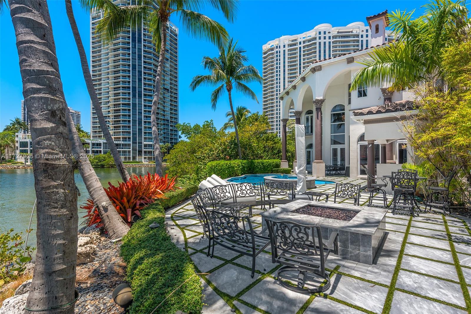 3914 Island Estates Drive Aventura, FL 33160 - Photo 8 of 40 a view of a patio with table and chairs and potted plants