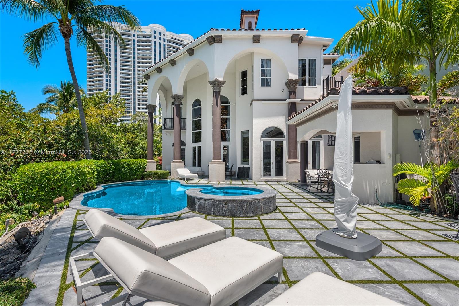 3914 Island Estates Drive Aventura, FL 33160 - Photo 9 of 40 a view of a white house with a chairs and table in a patio