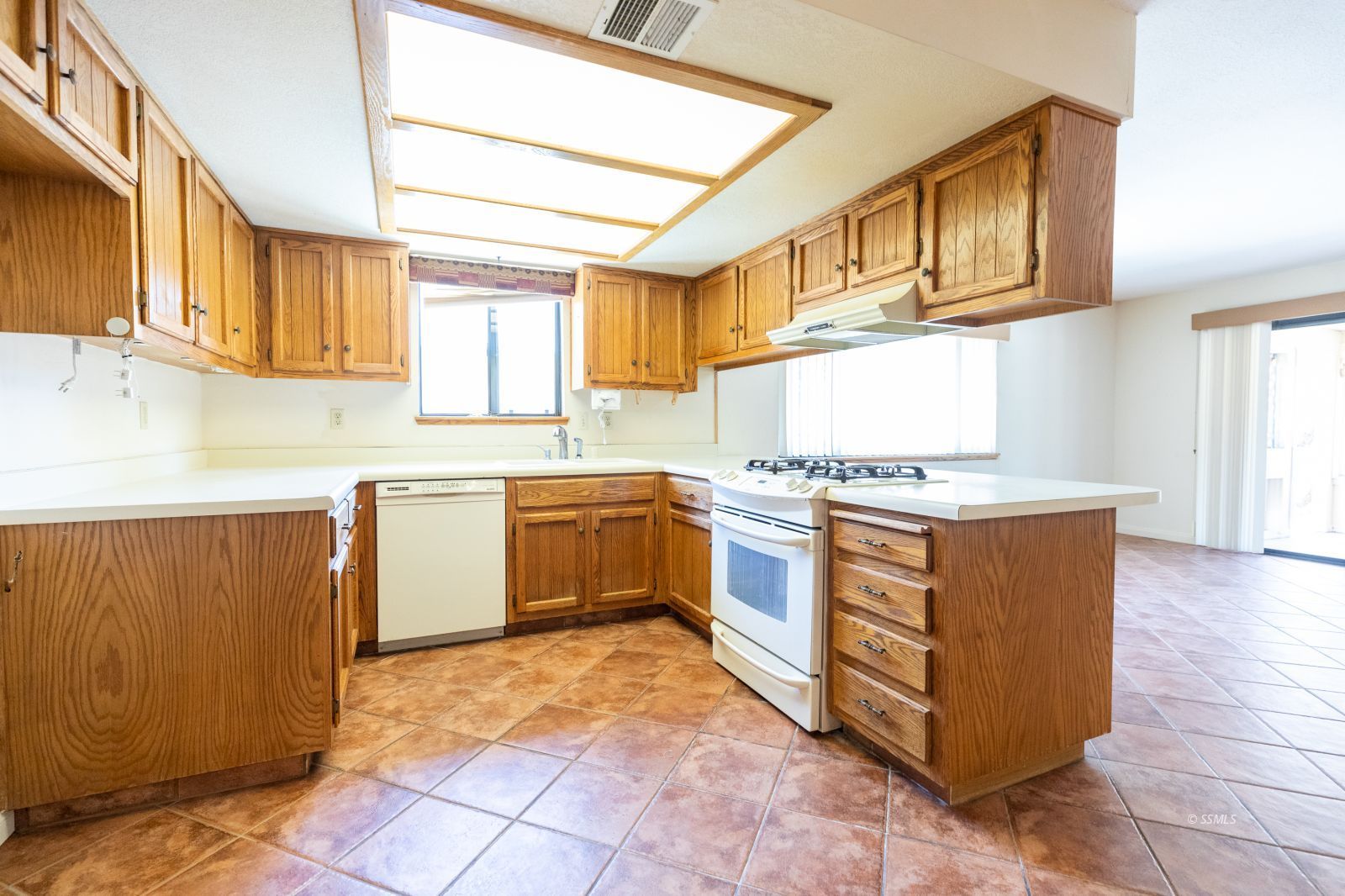 813 West Perdew Avenue Ridgecrest, CA 93555 - Photo 10 of 28 a kitchen with stainless steel appliances granite countertop a stove a sink and a microwave