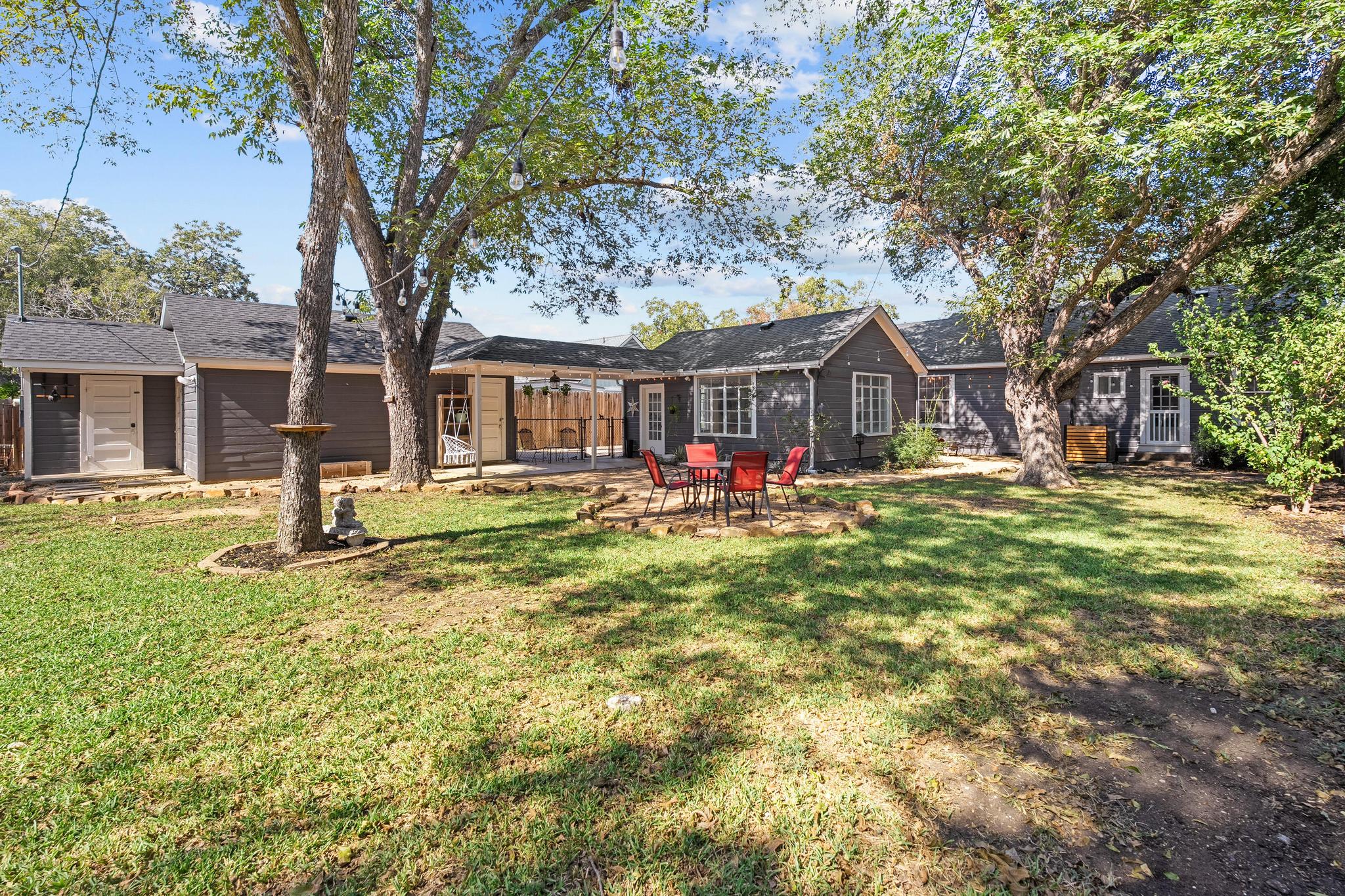 1707 Lexington Street Taylor, TX 76574 - Photo 26 of 29 Back of house featuring a yard, a patio area, and a shingled roof