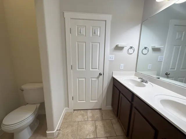 a view of bathroom with a toilet sink and mirror