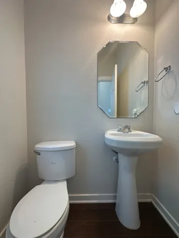 a white toilet sitting next to a bathroom sink