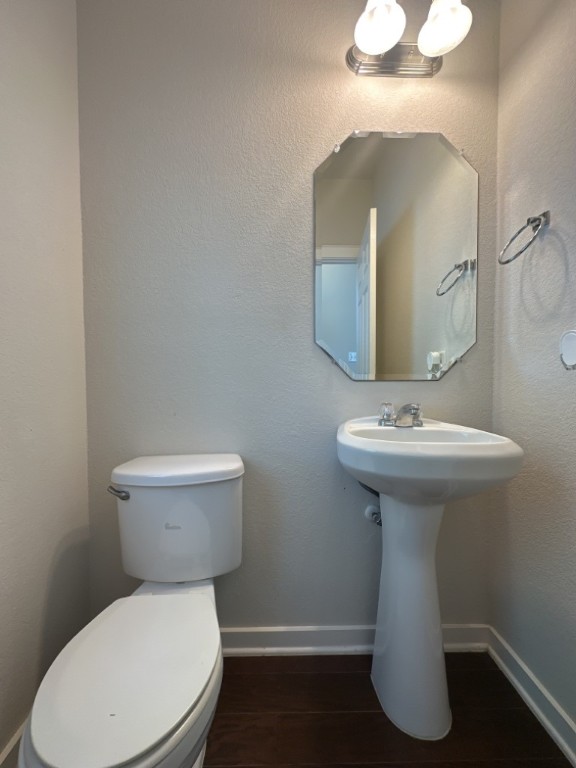 2101 Rivers Edge Way, Unit 32 Austin, TX 78741 - Photo 20 of 22 a white toilet sitting next to a bathroom sink