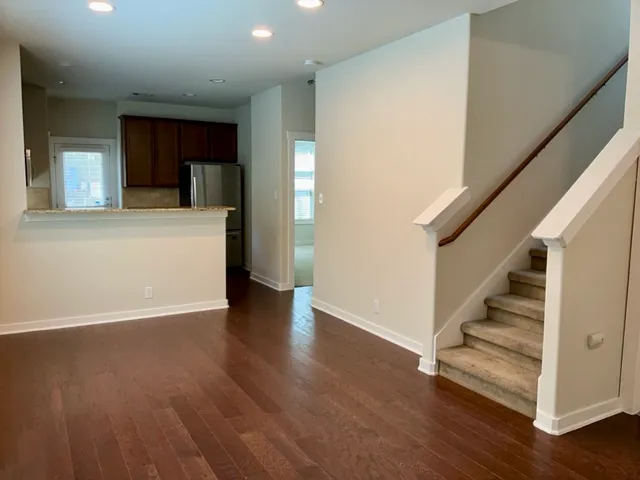 a view of an entryway with wooden floor and stairs