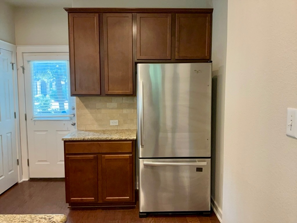2101 Rivers Edge Way, Unit 32 Austin, TX 78741 - Photo 8 of 22 a white refrigerator freezer sitting in a kitchen