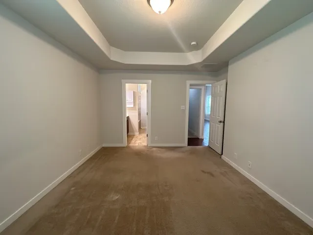 an empty room with windows and entrance