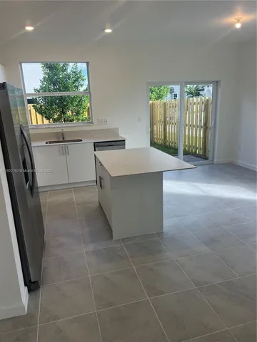 a view of kitchen with furniture and window