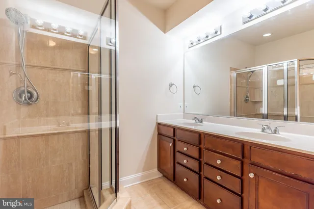 an empty room with windows and ceiling fan