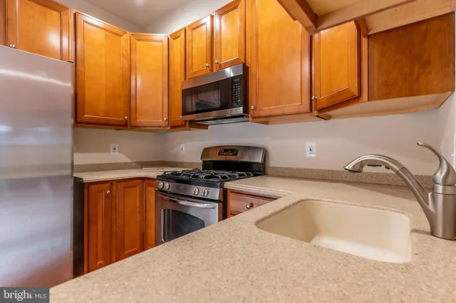 a kitchen with granite countertop a stove and a sink