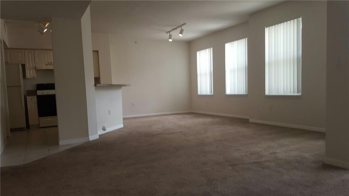 6720 West Sample Road, Unit 6720 Coral Springs, FL 33067 - Photo 2 of 8 an empty room with windows and closet
