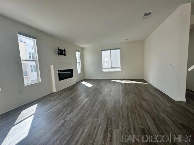 2036 Mayon Road Chula Vista, CA 91915 - Photo 11 of 49 a view of main area fire place window and wooden floor