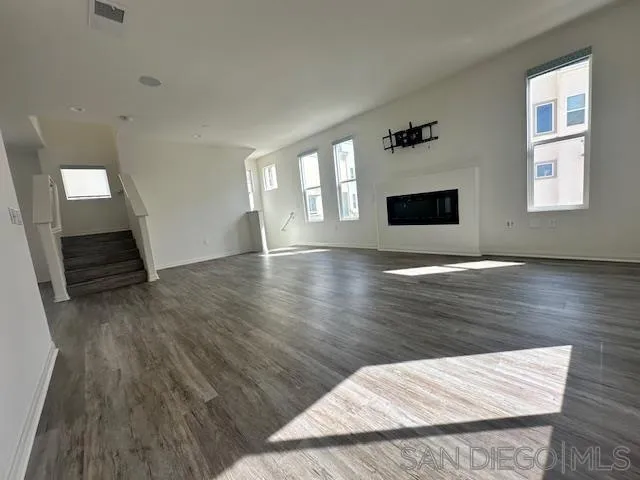 2036 Mayon Road Chula Vista, CA 91915 - Photo 12 of 49 a view of an empty room with wooden floor and a window