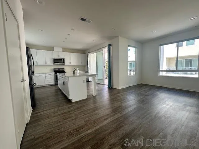 2036 Mayon Road Chula Vista, CA 91915 - Photo 15 of 49 a kitchen with stainless steel appliances a refrigerator sink and cabinets