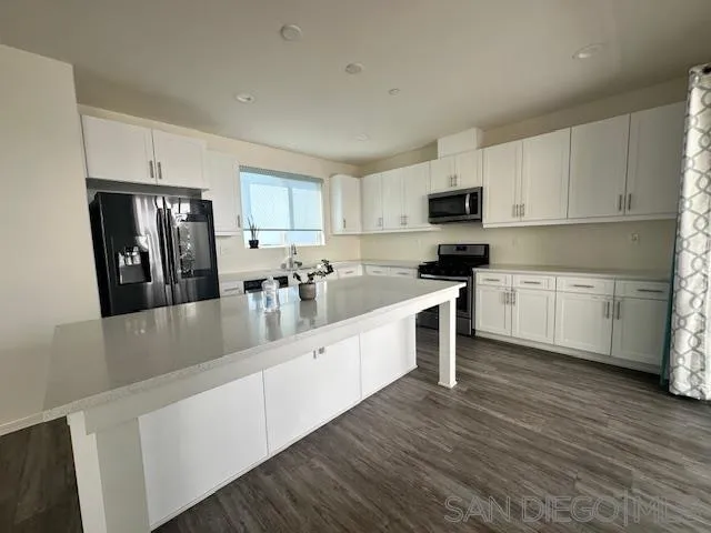 2036 Mayon Road Chula Vista, CA 91915 - Photo 17 of 49 a large kitchen with cabinets stainless steel appliances a sink and a center island