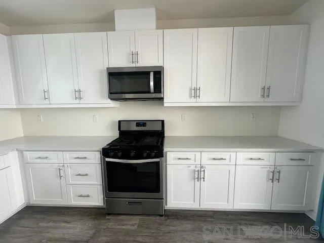 2036 Mayon Road Chula Vista, CA 91915 - Photo 18 of 49 a kitchen with white cabinets and appliances
