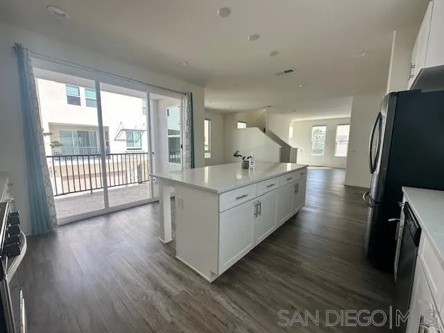2036 Mayon Road Chula Vista, CA 91915 - Photo 20 of 49 a large white kitchen with wooden floor and a large window