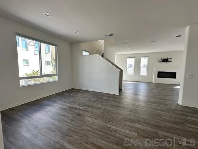 2036 Mayon Road Chula Vista, CA 91915 - Photo 21 of 49 a view of an empty room with wooden floor and a window