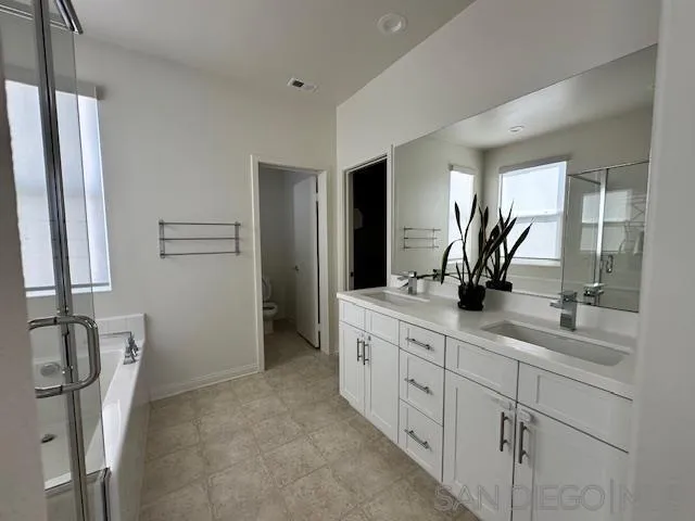 2036 Mayon Road Chula Vista, CA 91915 - Photo 26 of 49 a bathroom with a double vanity sink and mirror