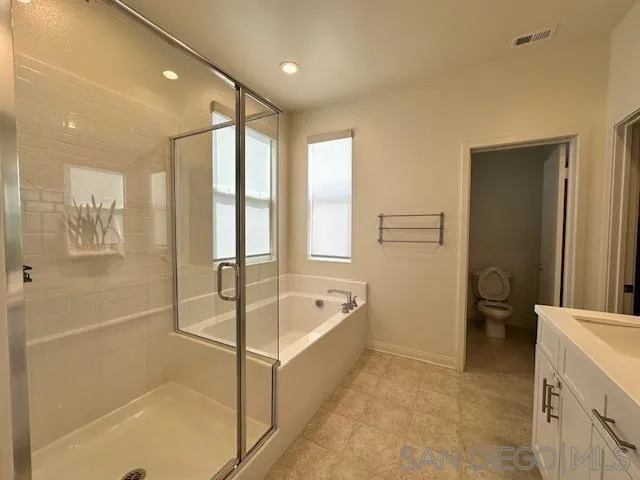 2036 Mayon Road Chula Vista, CA 91915 - Photo 28 of 49 a spacious bathroom with a tub shower and mirror