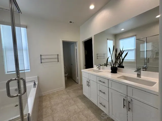 2036 Mayon Road Chula Vista, CA 91915 - Photo 29 of 49 a spacious bathroom with a double vanity sink a mirror and shower