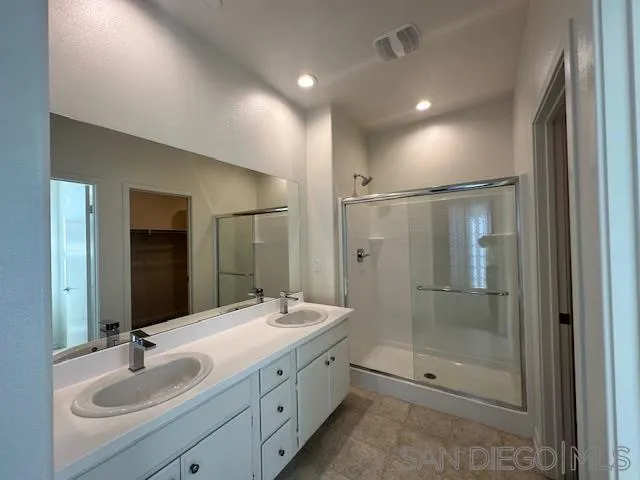 2036 Mayon Road Chula Vista, CA 91915 - Photo 4 of 49 a bathroom with a double vanity sink mirror and shower