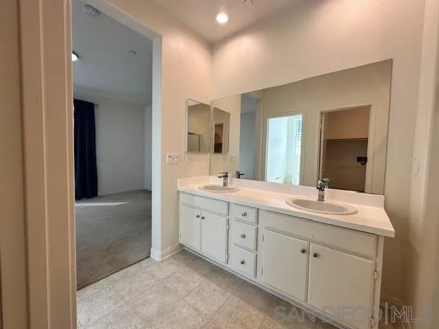 2036 Mayon Road Chula Vista, CA 91915 - Photo 6 of 49 a spacious bathroom with a double vanity sink and a mirror