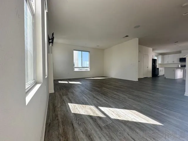 2036 Mayon Road Chula Vista, CA 91915 - Photo 9 of 49 a view of an empty room with wooden floor and a window