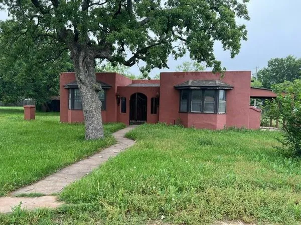 a front view of house with yard and green space