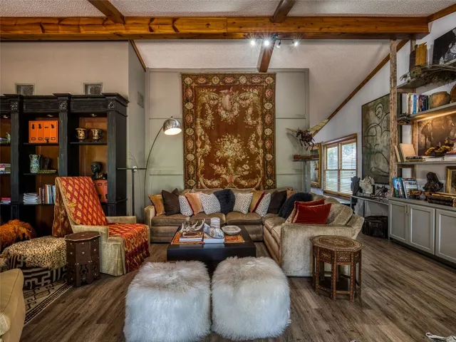 a living room with patio furniture and a fireplace