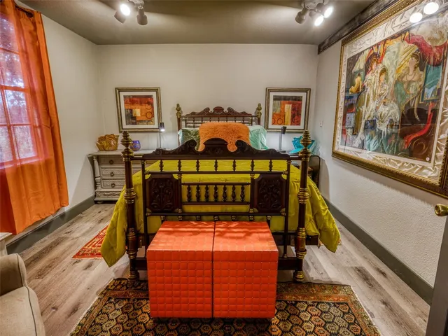 a bed room with furniture and paintings on the wall