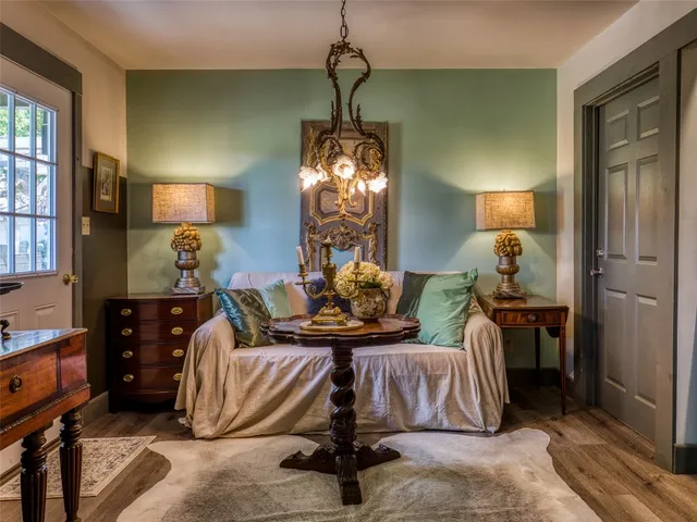 a living room with furniture a lamp and a chandelier