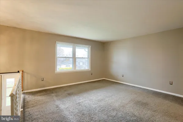 an empty room with a empty space and windows