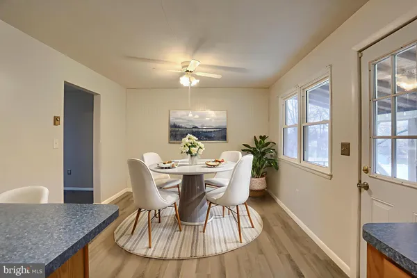 a view of a dining room with furniture window and wooden floor