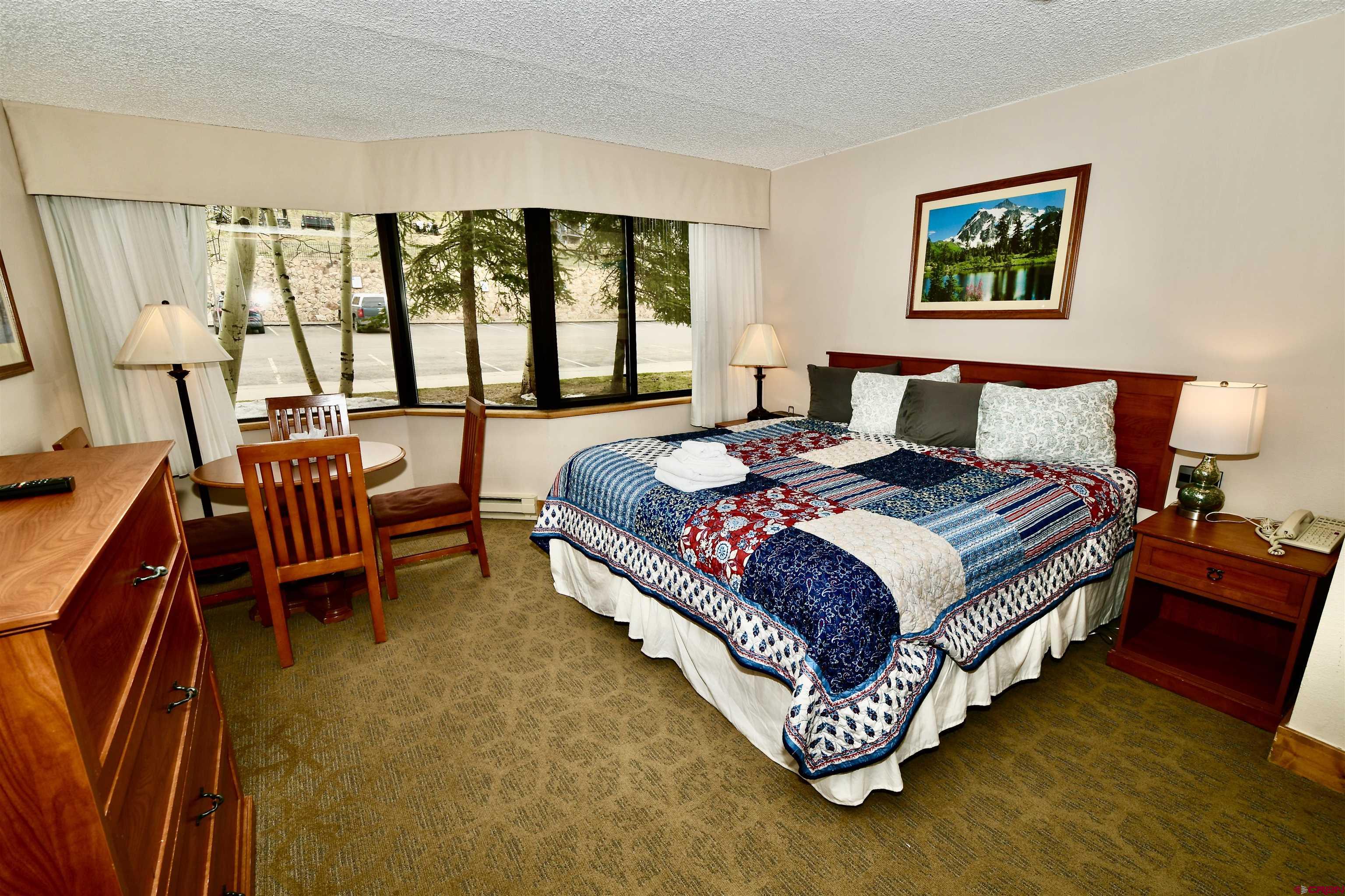 a bed sitting in a bedroom next to a window