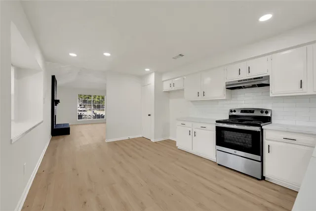 a kitchen with stainless steel appliances granite countertop a stove and a refrigerator