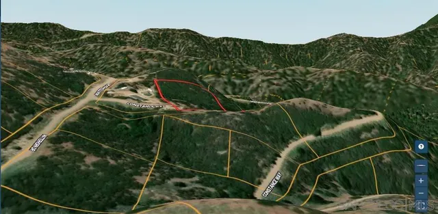 a view of a dry space with mountains in the background