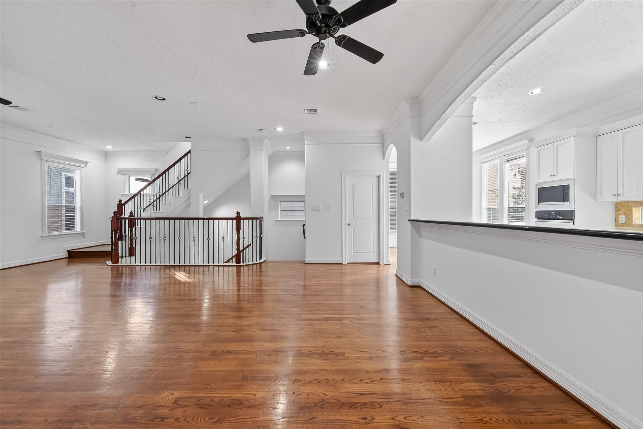 1002 West 22nd Street Houston, TX 77008 - Photo 12 of 43 a view of a kitchen and an empty room with wooden floor