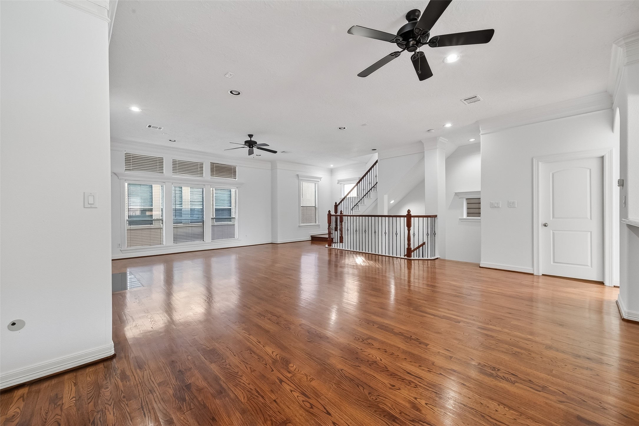 1002 West 22nd Street Houston, TX 77008 - Photo 13 of 43 an empty room with wooden floor ceiling fan and windows