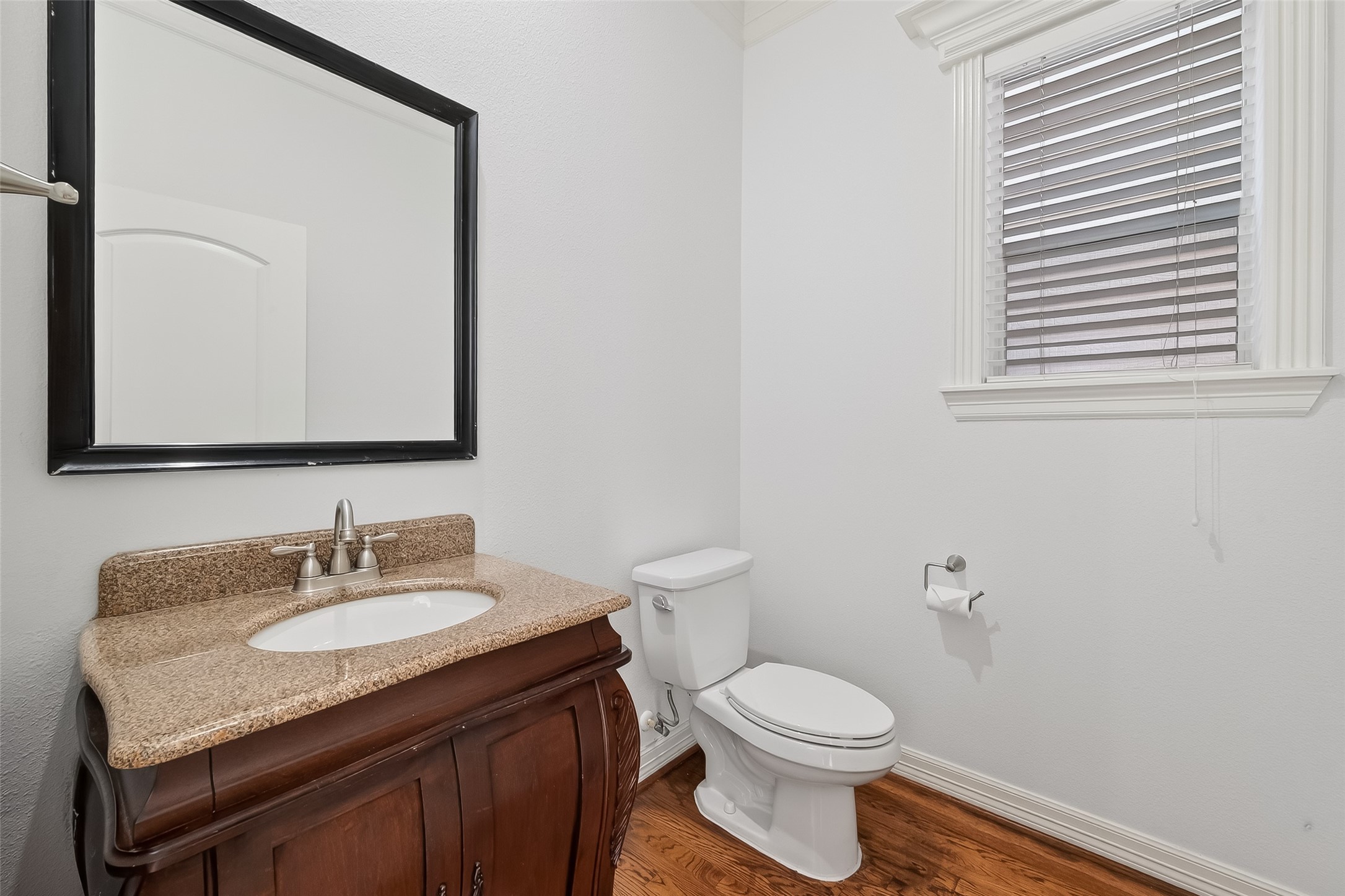1002 West 22nd Street Houston, TX 77008 - Photo 14 of 43 a bathroom with a granite countertop sink toilet and mirror