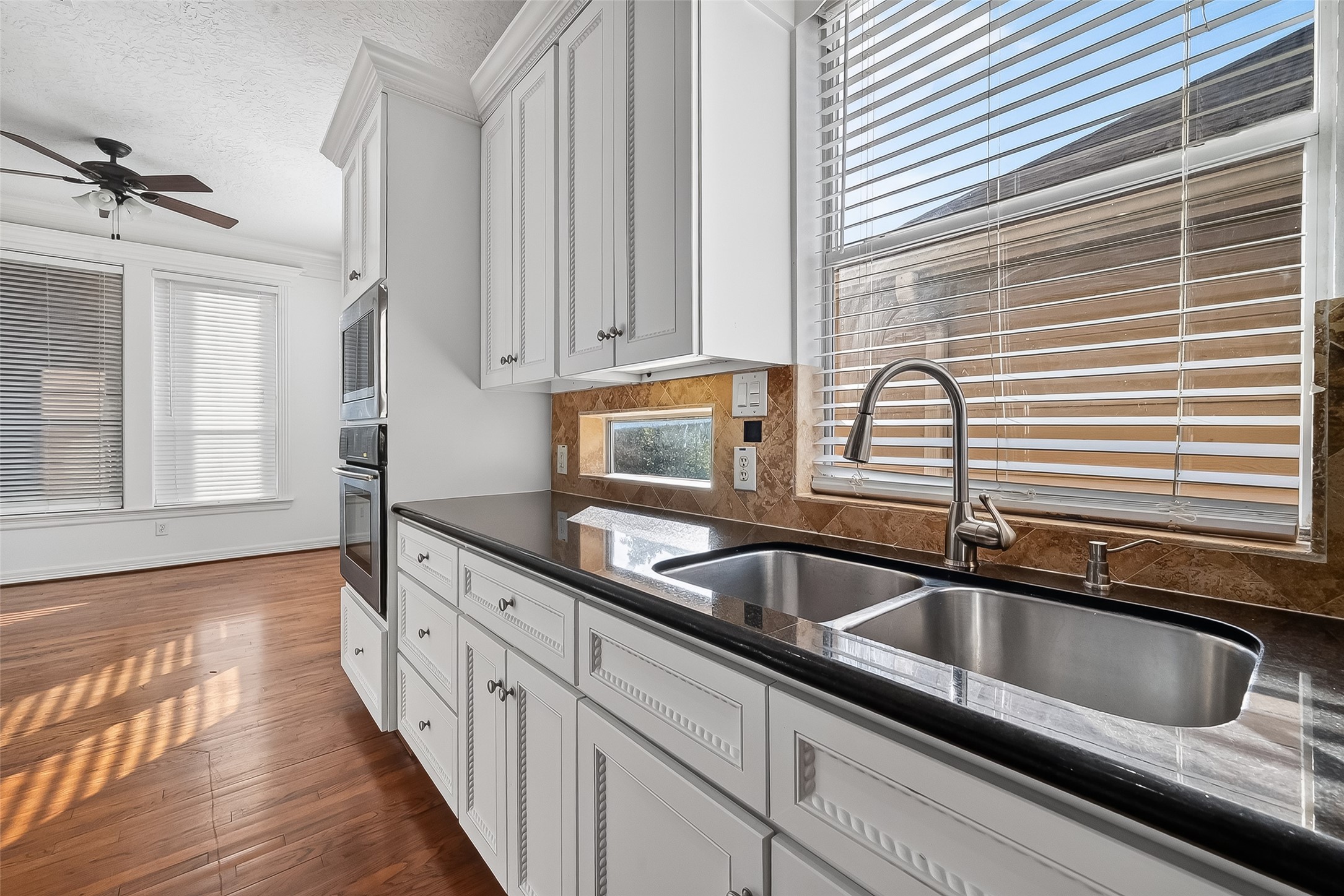 1002 West 22nd Street Houston, TX 77008 - Photo 24 of 43 a kitchen with granite countertop a sink and a window