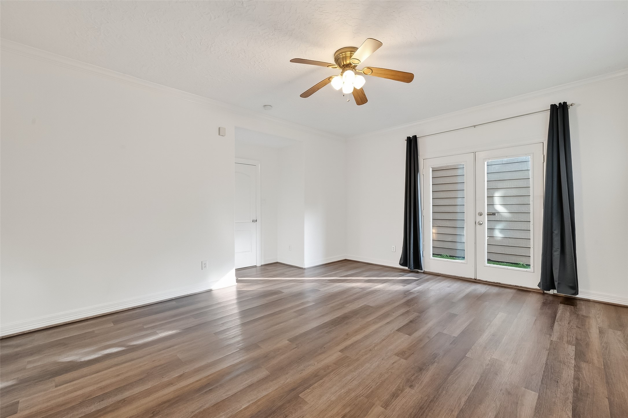 1002 West 22nd Street Houston, TX 77008 - Photo 26 of 43 an empty room with wooden floor chandelier and windows