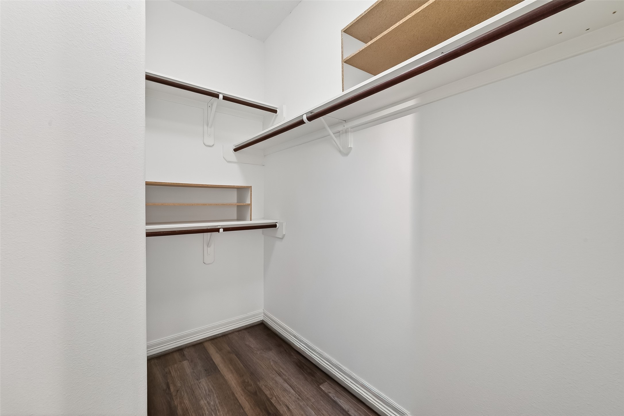 1002 West 22nd Street Houston, TX 77008 - Photo 27 of 43 a view of walk in closet with empty racks