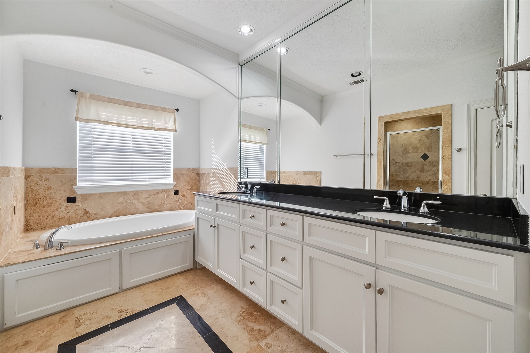 1002 West 22nd Street Houston, TX 77008 - Photo 35 of 43 a bathroom with a granite countertop double vanity sink a mirror and a bathtub