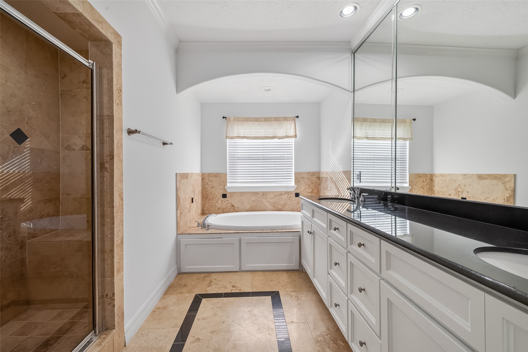 1002 West 22nd Street Houston, TX 77008 - Photo 36 of 43 a bathroom with a double vanity sink a mirror and a bathtub