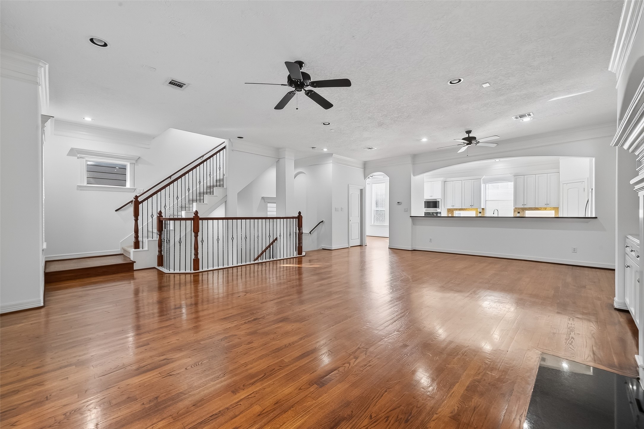 1002 West 22nd Street Houston, TX 77008 - Photo 8 of 43 a view of a hallway with wooden floor and kitchen view
