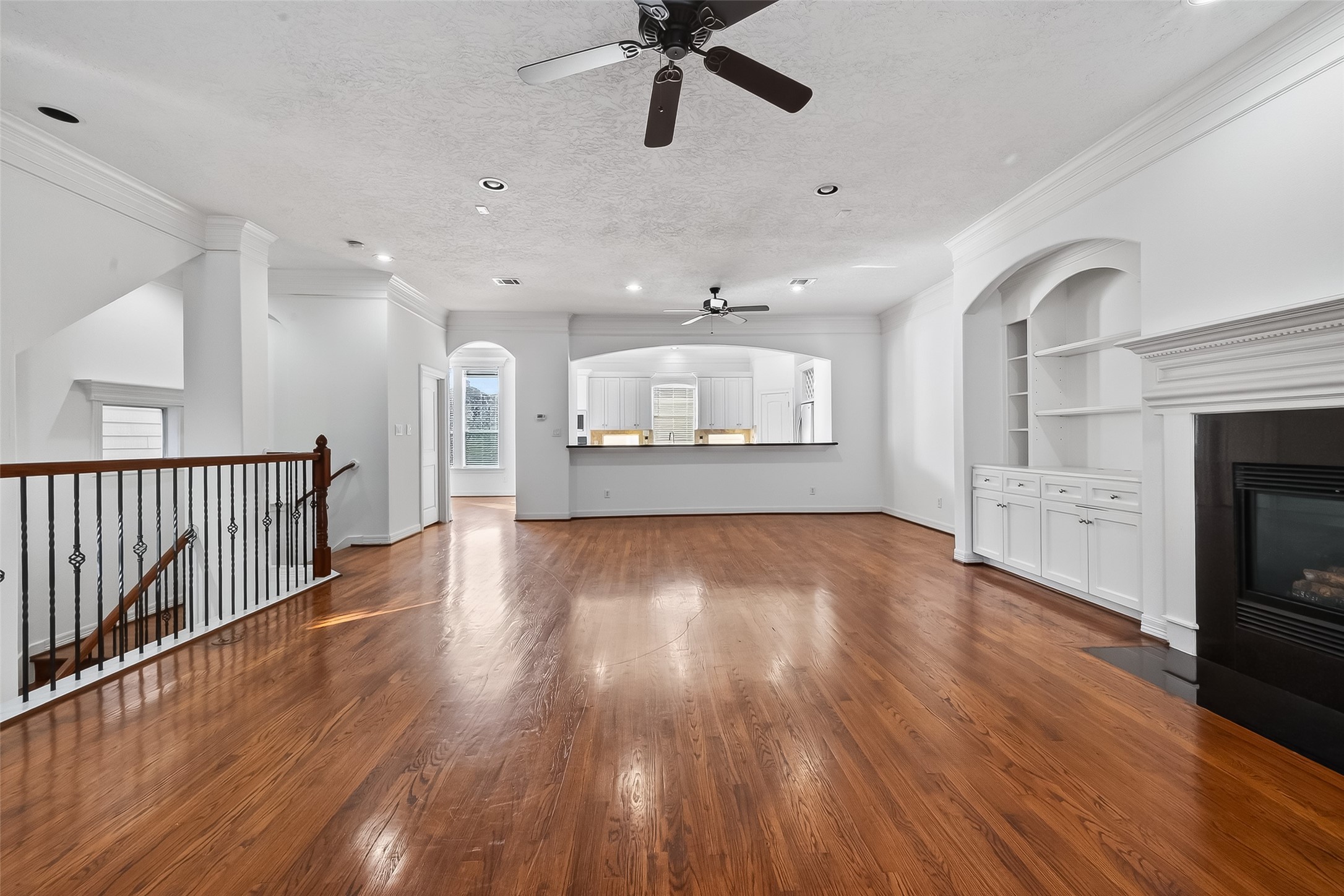 1002 West 22nd Street Houston, TX 77008 - Photo 9 of 43 a view of a kitchen and an empty room with wooden floor