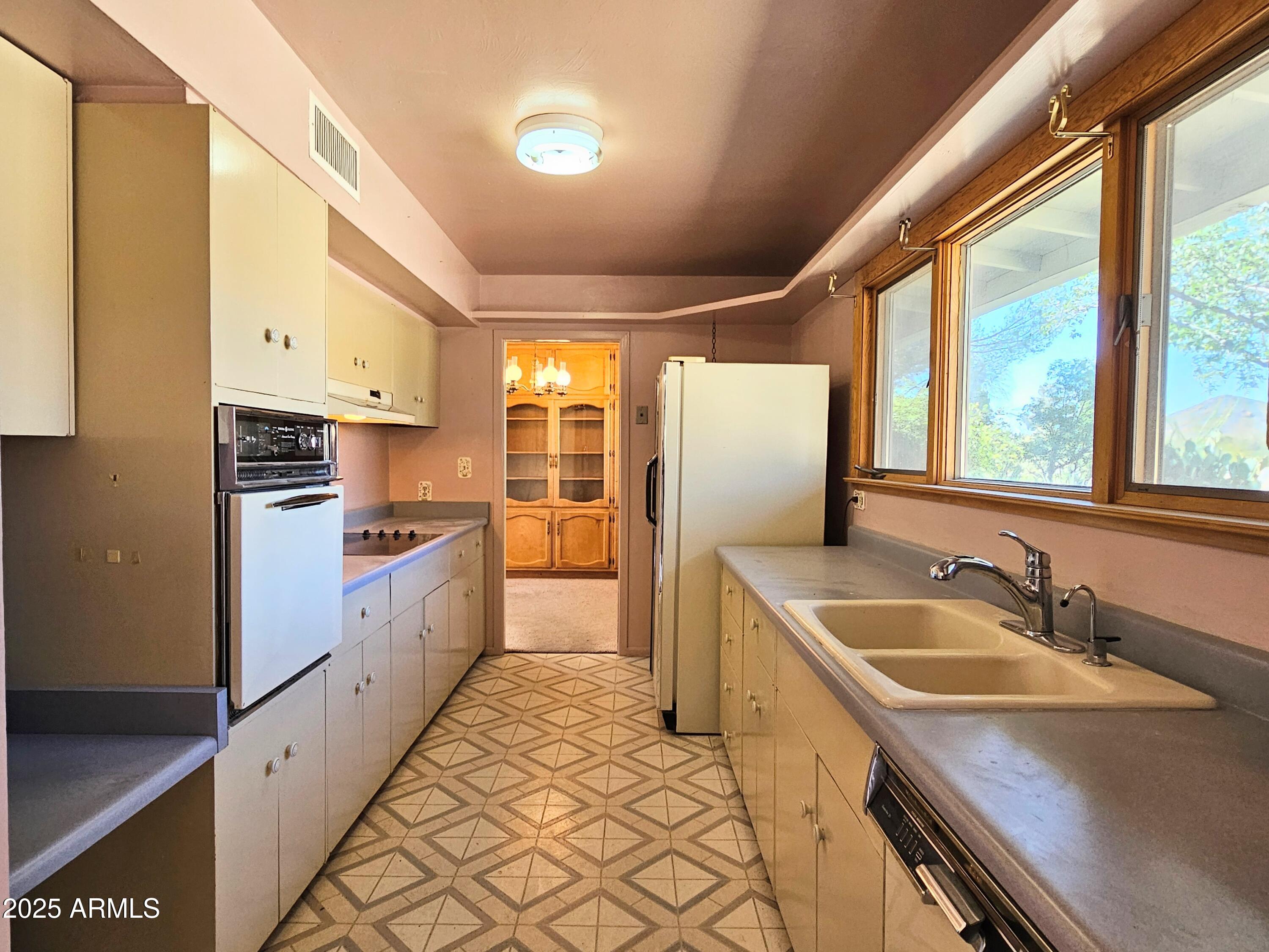 85 Pima Drive Bisbee, AZ 85603 - Photo 14 of 44 a kitchen with granite countertop a sink stove and refrigerator