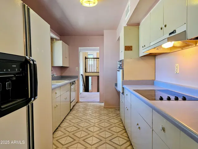 a kitchen with a stove and a refrigerator