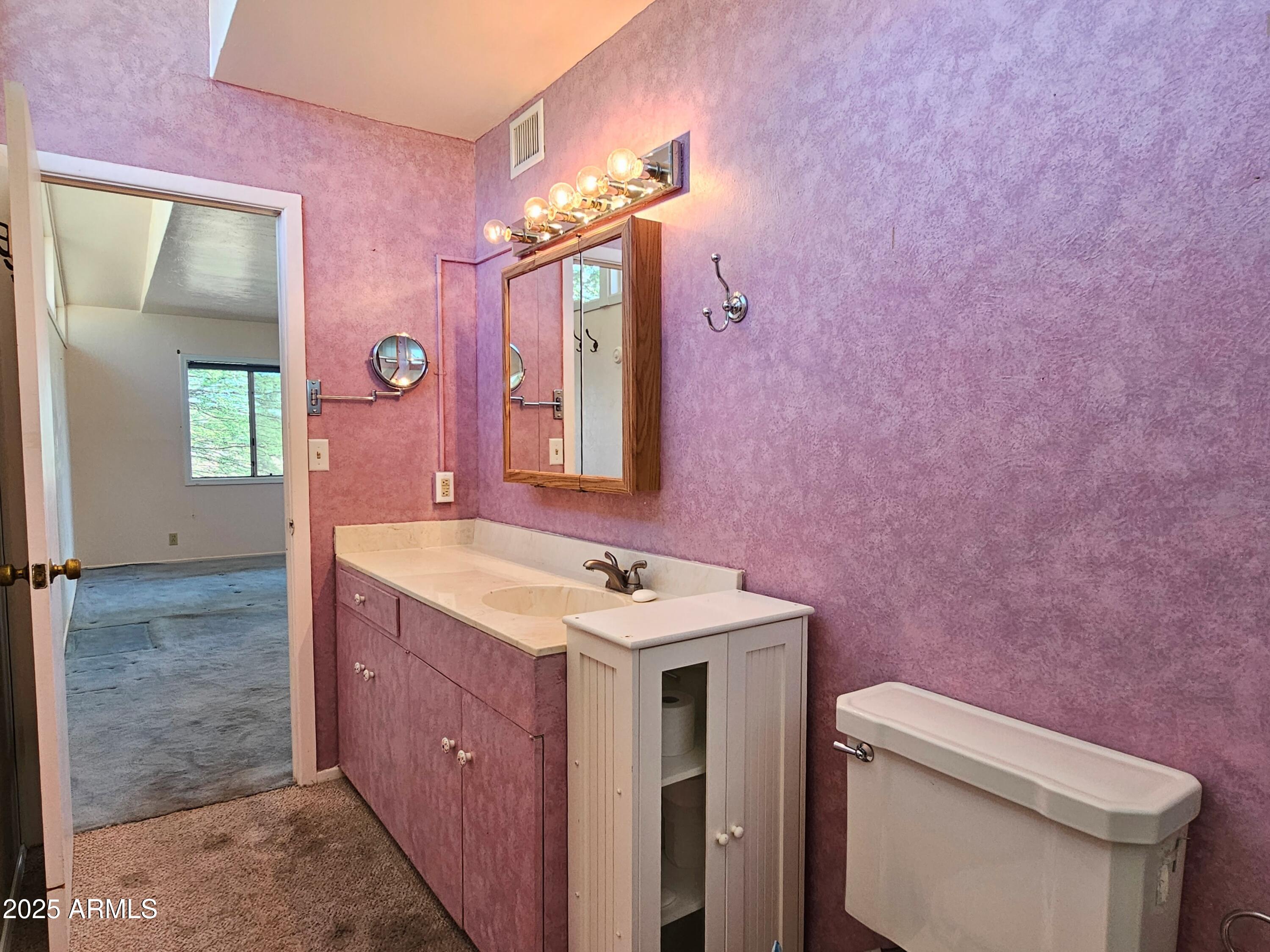85 Pima Drive Bisbee, AZ 85603 - Photo 23 of 44 a bathroom with a sink a toilet and mirror